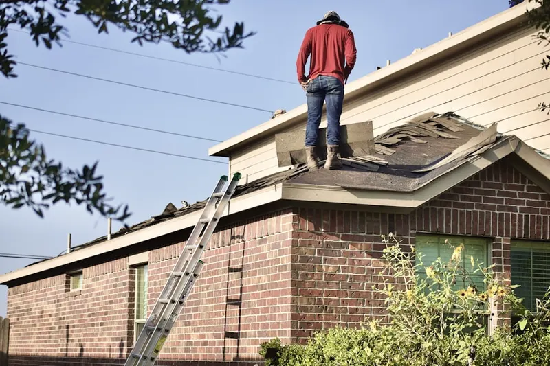 Professional roofer working on a residential roof in Purnell